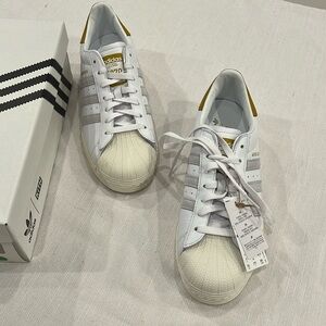 - Adidas Kith White and Gold Sneakers